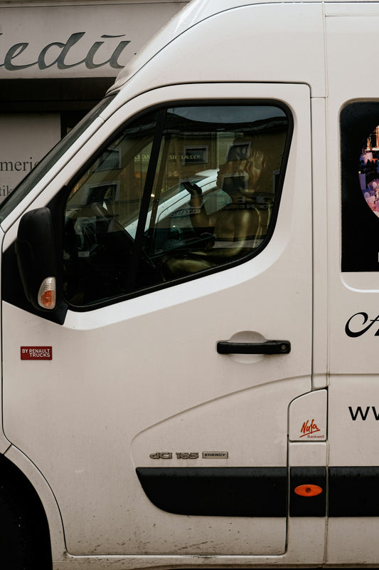 a white van parked in front of a building
